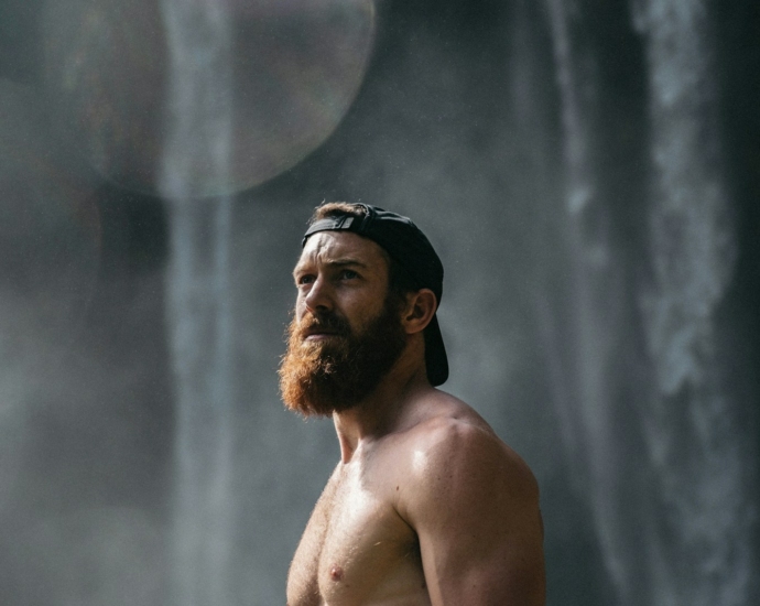 topless man wearing black fitted cap