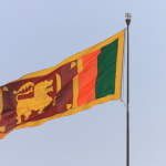 the flag of sri is flying high in the sky