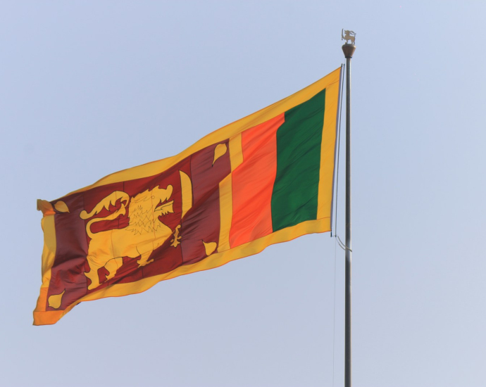 the flag of sri is flying high in the sky