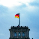 A tall building with a flag on top of it