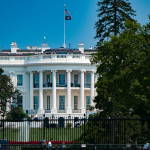 a large white building with a flag on top of it