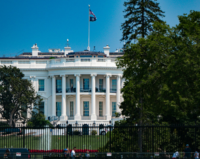 a large white building with a flag on top of it