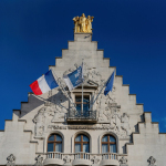 A tall building with a flag on top of it