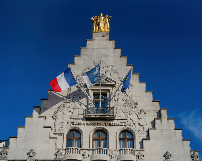 A tall building with a flag on top of it