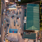 an aerial view of a parking lot with a green roof