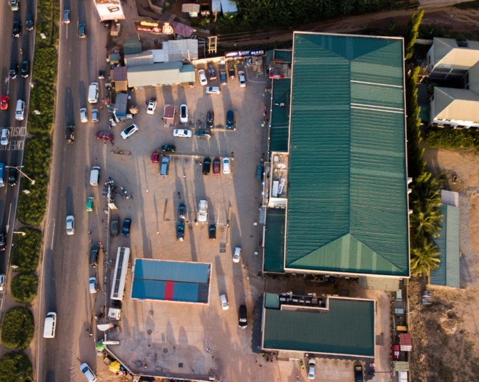 an aerial view of a parking lot with a green roof