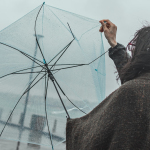 woman in black jacket holding umbrella