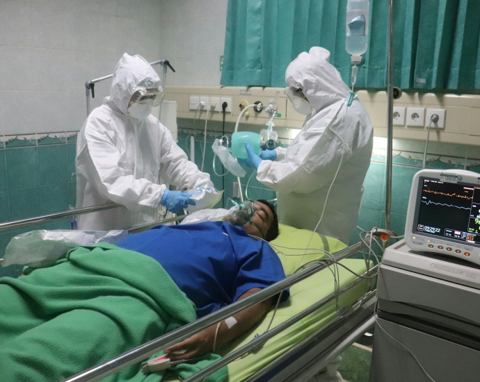 man in white medical scrub lying on hospital bed