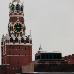 low angle photo of red concrete tower clock