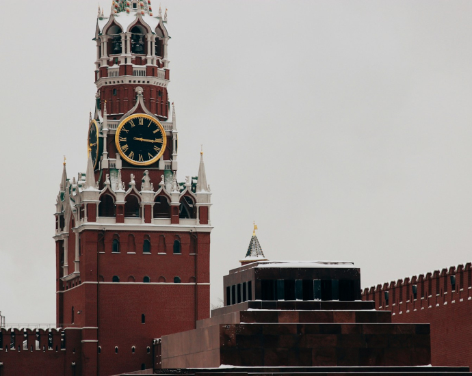 low angle photo of red concrete tower clock