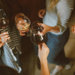 group of people tossing wine glass