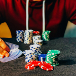 person sitting near poker chips