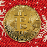 a bit coin sitting on top of a red and white blanket