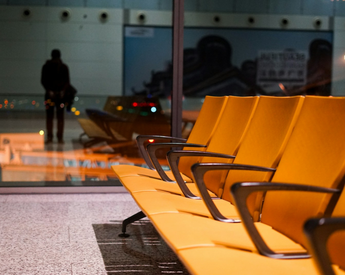 a row of yellow chairs sitting on top of a floor