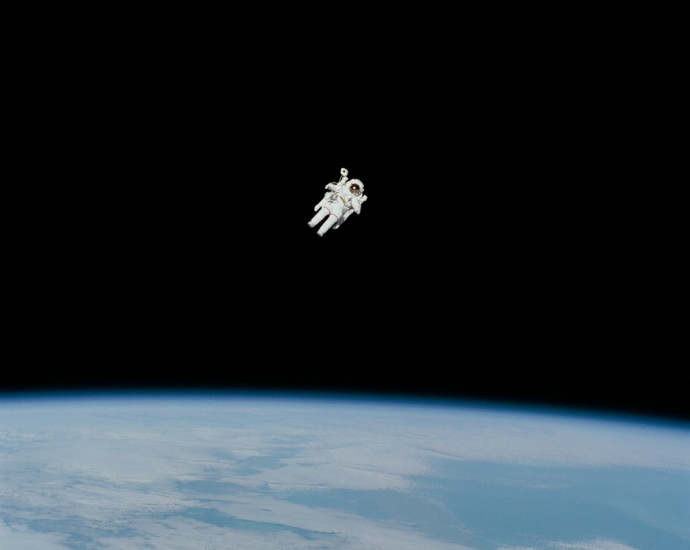 astronaut in spacesuit floating in space