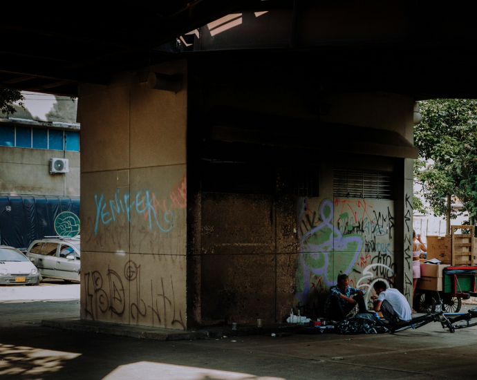 a group of people sitting on the side of a building