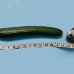 gourd and white tape measure on blue surface