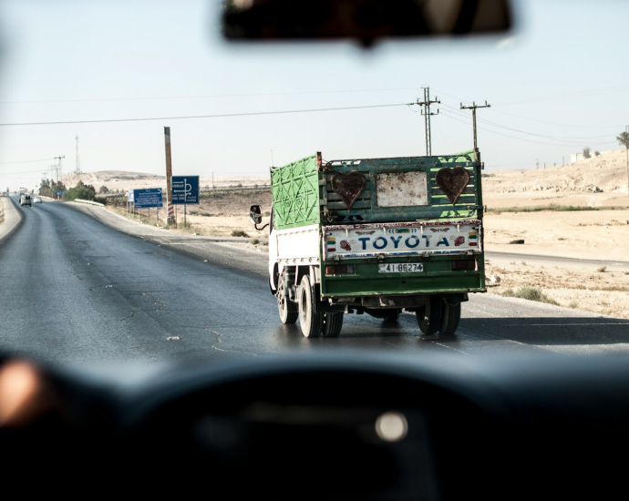 green and white Toyota truck under clear sky during daytime