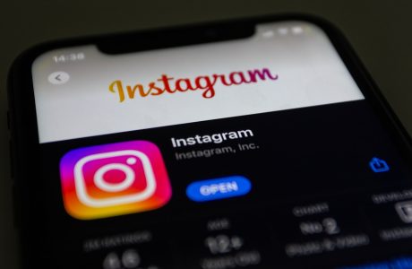 the instagram logo is displayed on an iphone