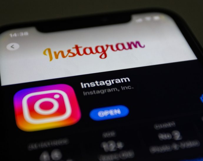 the instagram logo is displayed on an iphone