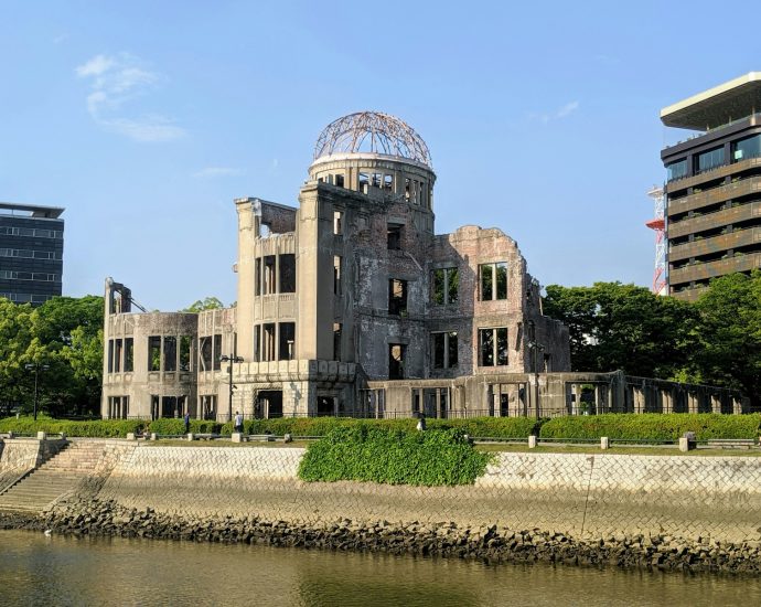 brown concrete building near body of water during daytime