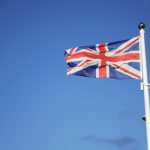 us a flag on pole under blue sky during daytime