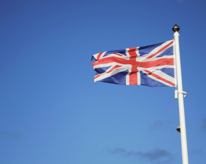 us a flag on pole under blue sky during daytime