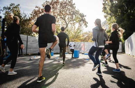 man in black t-shirt and black shorts running on road during daytime