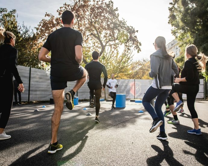 man in black t-shirt and black shorts running on road during daytime