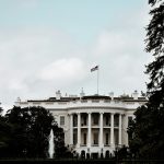a white house with a flag on top of it