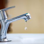 a faucet with a drop of water coming out of it