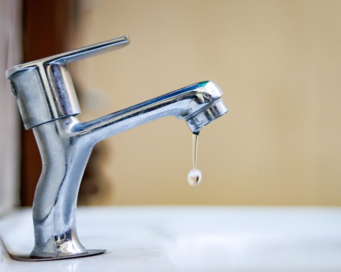 a faucet with a drop of water coming out of it