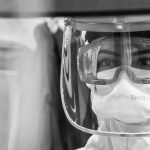 grayscale photo of man wearing goggles