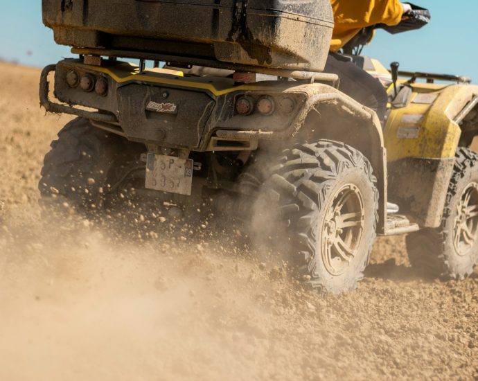 yellow and black front loader on beach during daytime