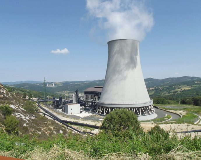 a factory with smoke coming out of it's stacks
