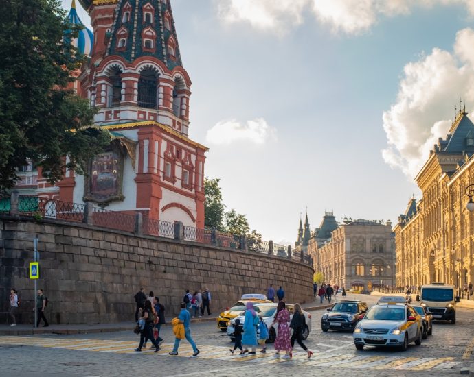 people crossing street during daytime