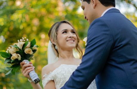 a bride and groom holding a bouquet of flowers