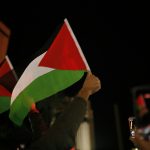 person holding green white and red flag