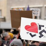 a group of people holding up signs in the air