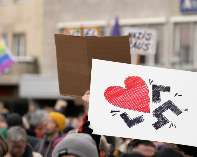a group of people holding up signs in the air