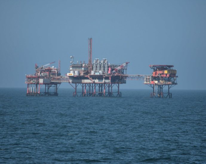 a group of oil rigs sitting on top of a large body of water