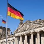 a german flag flying in front of a building
