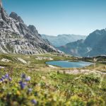 lake surrounded by rocky mountains at daytime
