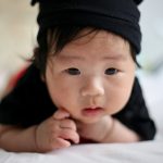 shallow focus photo of baby wearing black knit cap