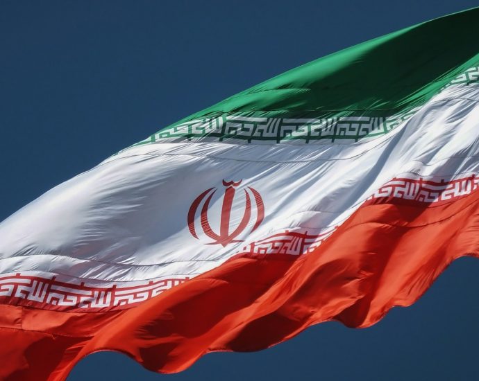 the flag of the country of iraq flying in the sky