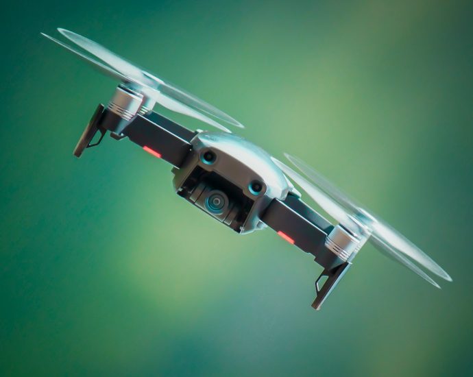 selective focus photography of gray and black quadcopter drone