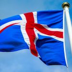 a blue and red flag flying in the wind