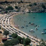 a beach with boats and people