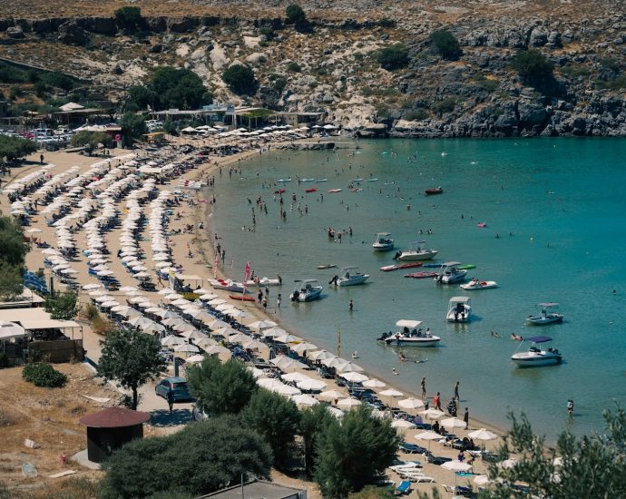 a beach with boats and people