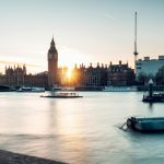 the sun is setting over the city of london